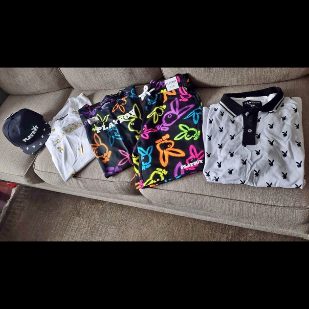 Three shirts one pair of shorts and a flat beak hat